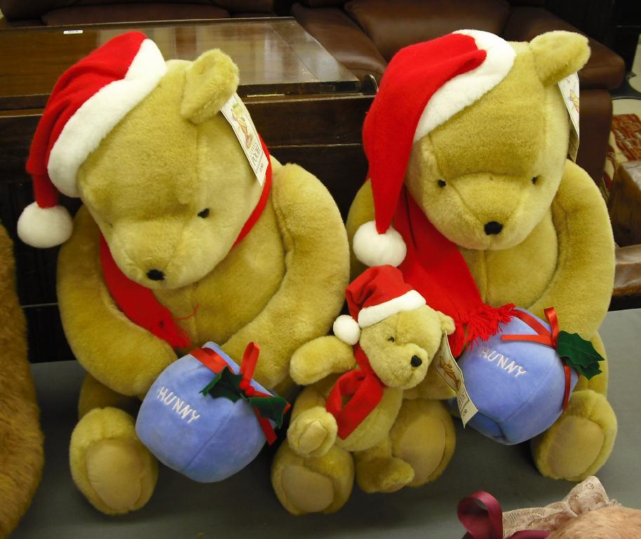 Appraisal: Two large identical Gund Christmas Pooh teddy bears both high