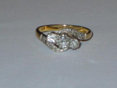 Appraisal: A THREE STONE DIAMOND RING the brilliant cut stones claw