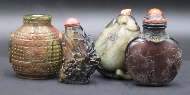 Appraisal: COLLECTION OF CARVED SNUFF BOTTLES Includes silver mounted carved stone