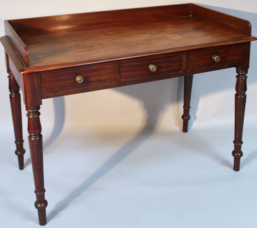 Appraisal: A Victorian mahogany wash stand with part galleried back and