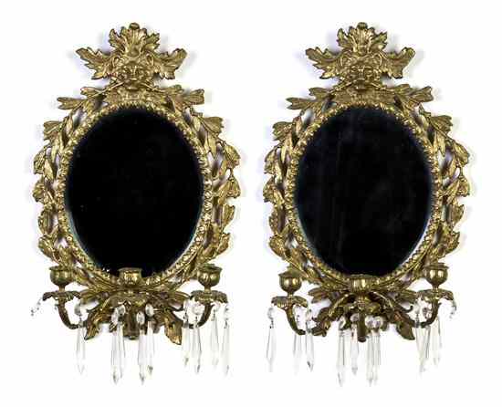 Appraisal: A Pair of Gilt Bronze Mirrored Sconces each with three