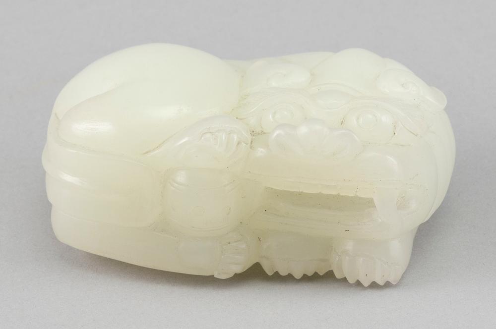 Appraisal: CHINESE CARVED WHITE JADE FIGURE OF A RECLINING FU DOG