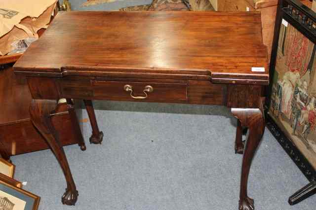 Appraisal: A GEORGIAN MAHOGANY FOLD OVER CARD TABLE the rectangular top