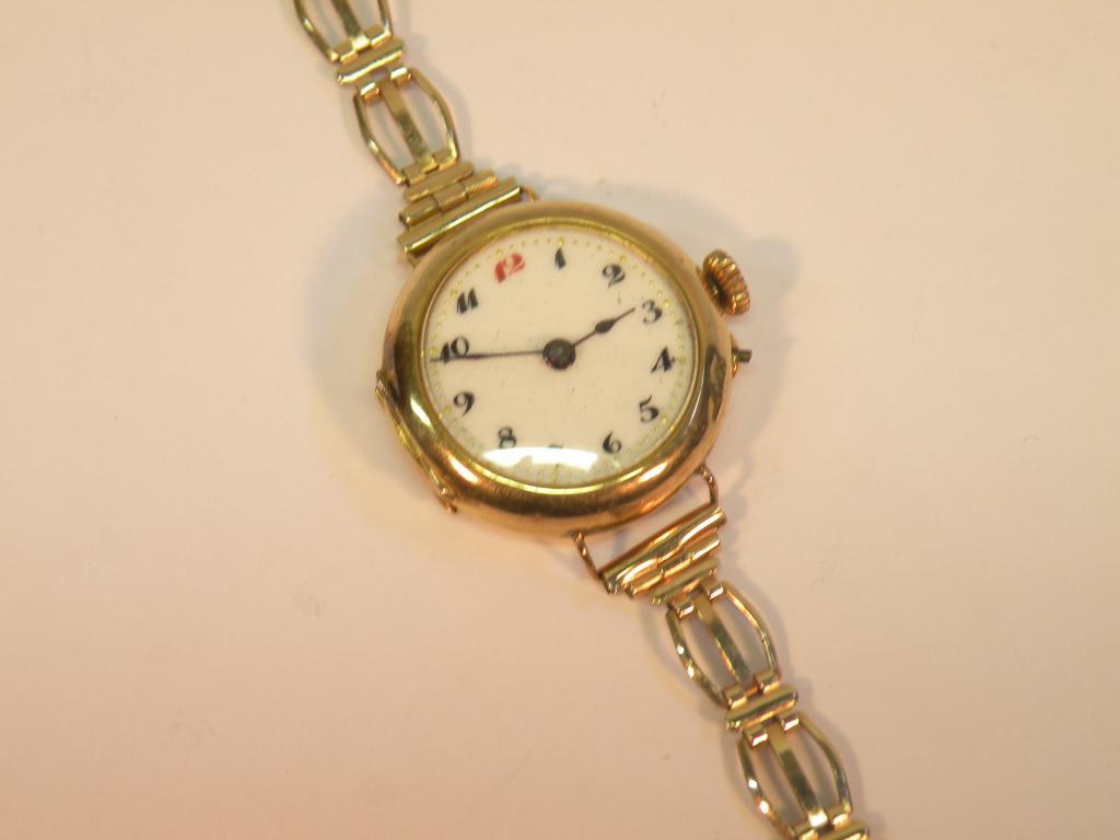 Appraisal: A lady's wrist watch with enamel dial and yellow metal