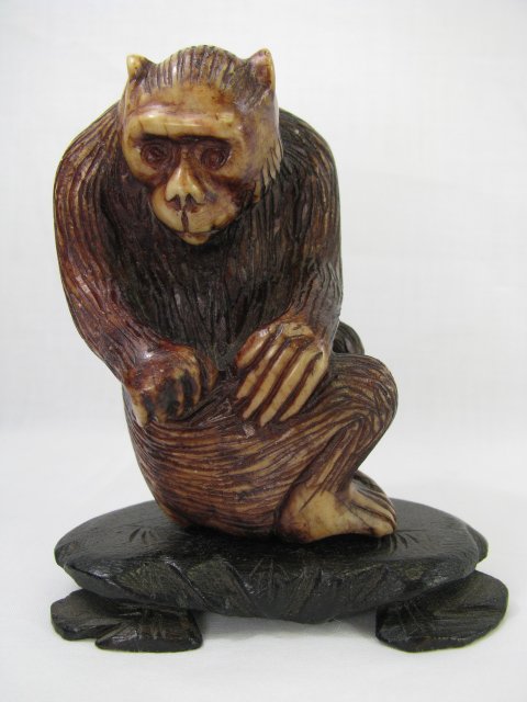 Appraisal: Chinese carved figure of an ape sitting Measures tall by