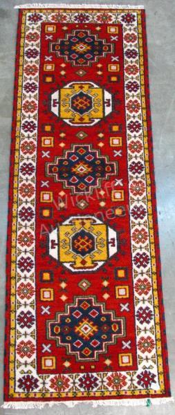 Appraisal: A Handmade Oriental Runner Kazak design red field with yellow