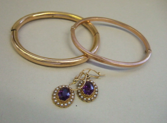 Appraisal: A ct gold oval hinged bangle another oval hinged bangle