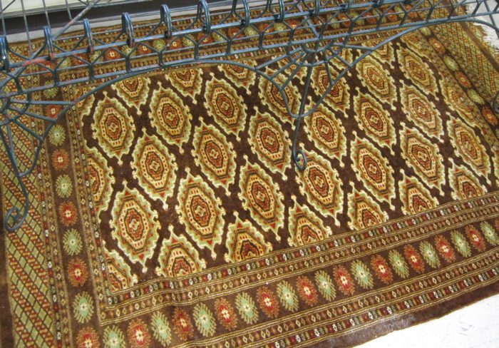 Appraisal: PAKISTANI BOKHARA AREA RUG repeating Turkoman gol design on brown