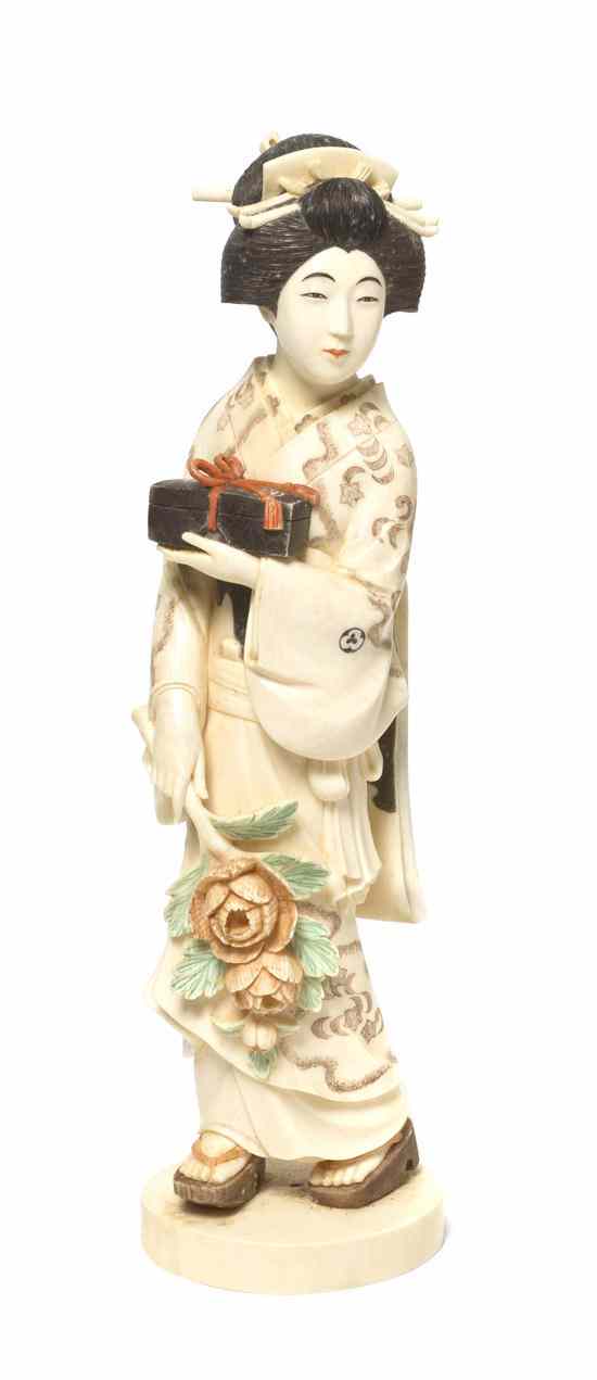 Appraisal: A Japanese Carved Ivory Okimono of a Lady depicted standing