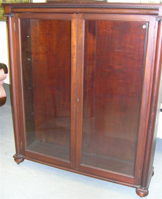 Appraisal: Mahogany standing bookcase with two glass doors ionic columns ''