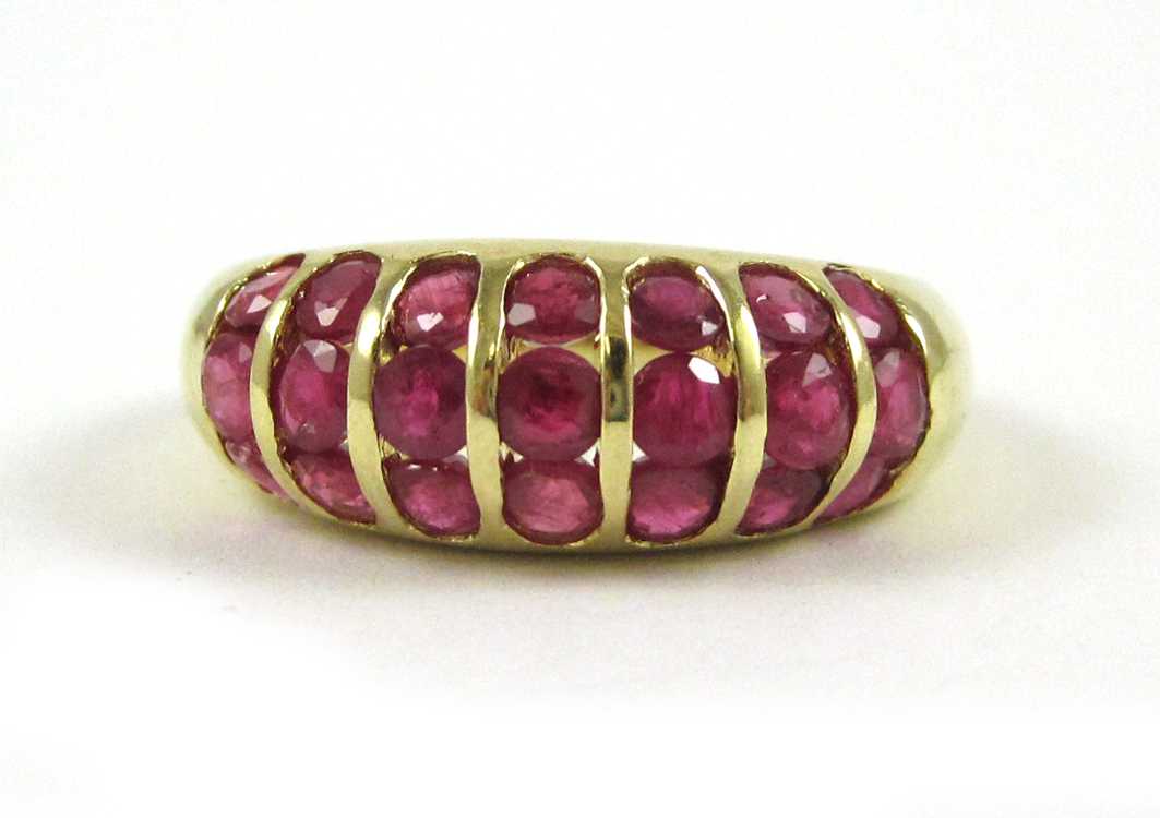 Appraisal: RUBY AND FOURTEEN KARAT GOLD RING with seven vertical rows