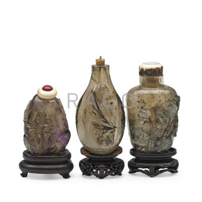 Appraisal: CHINESE ROCK CRYSTAL SNUFF BOTTLES Three with relief decoration and