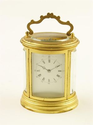 Appraisal: A th century French gilt brass oval mantel clock the