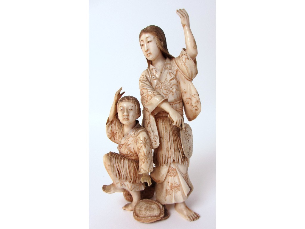 Appraisal: A Japanese ivory group of a mother and child she