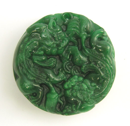 Appraisal: CHINESE CARVED JADE PENDANT The heavy round green jade pendant