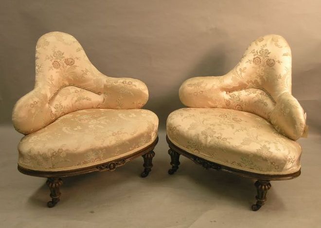 Appraisal: A pair of mid Victorian corner fitting conversation armchairs walnut