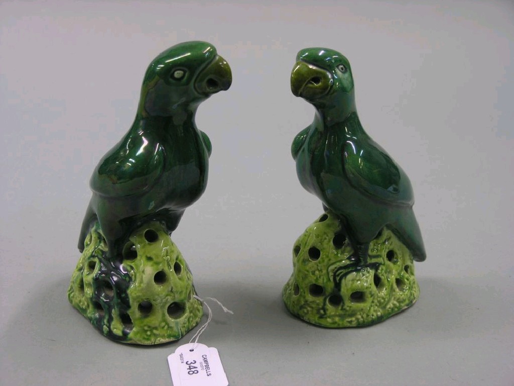 Appraisal: A pair of th century-style Chinese parrot models each upon