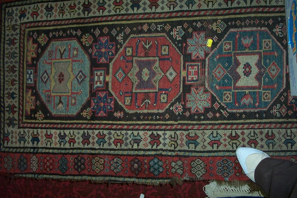 Appraisal: An eastern wool runner with repeating gul decoration with repeating