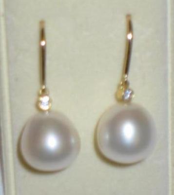 Appraisal: A PAIR OF PEARL AND DIAMOND EARRINGS the slightly pear