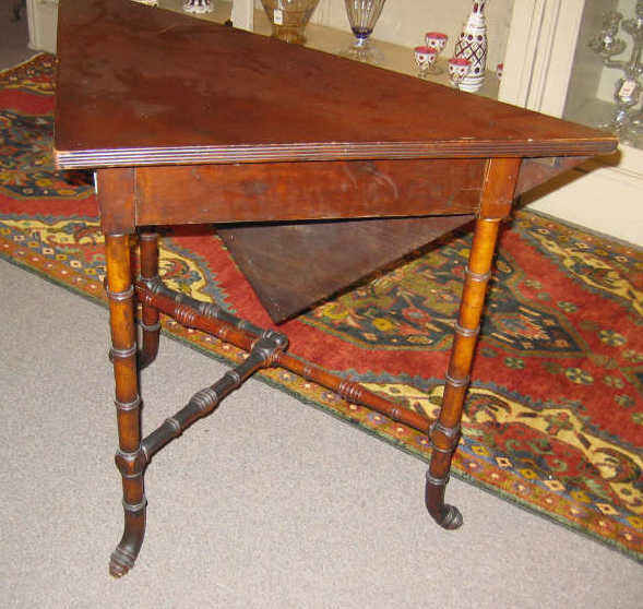 Appraisal: AMERICAN MAHOGANY DROP LEAF ENVELOPE TABLE Triangular top with a