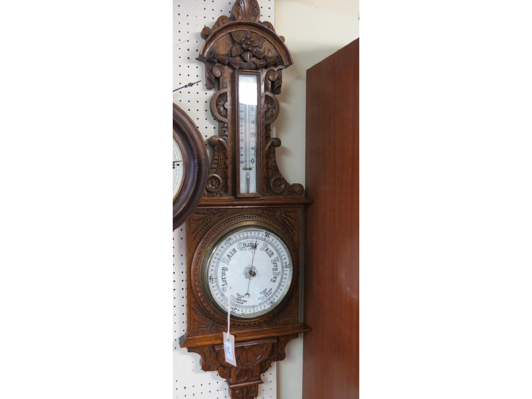 Appraisal: A Victorian carved oak wheel barometer with printed thermometer and