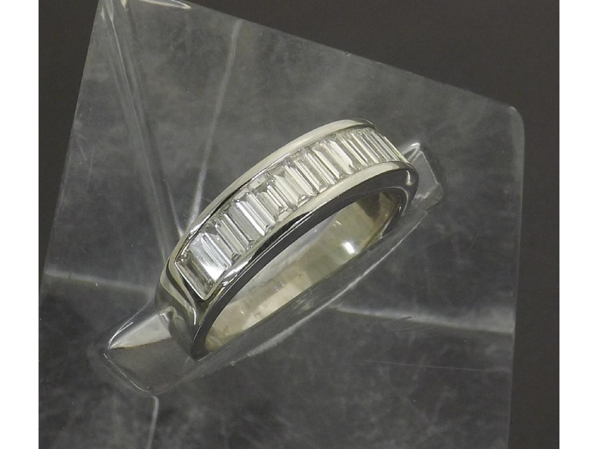 Appraisal: - -a Platinum baguette-cut diamond set half hoop ring estimated