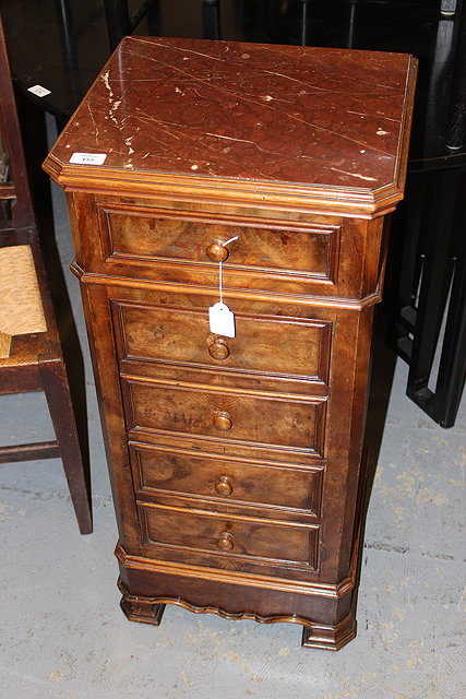 Appraisal: A CONTINENTAL WALNUT CUPBOARD with inset red marble top over