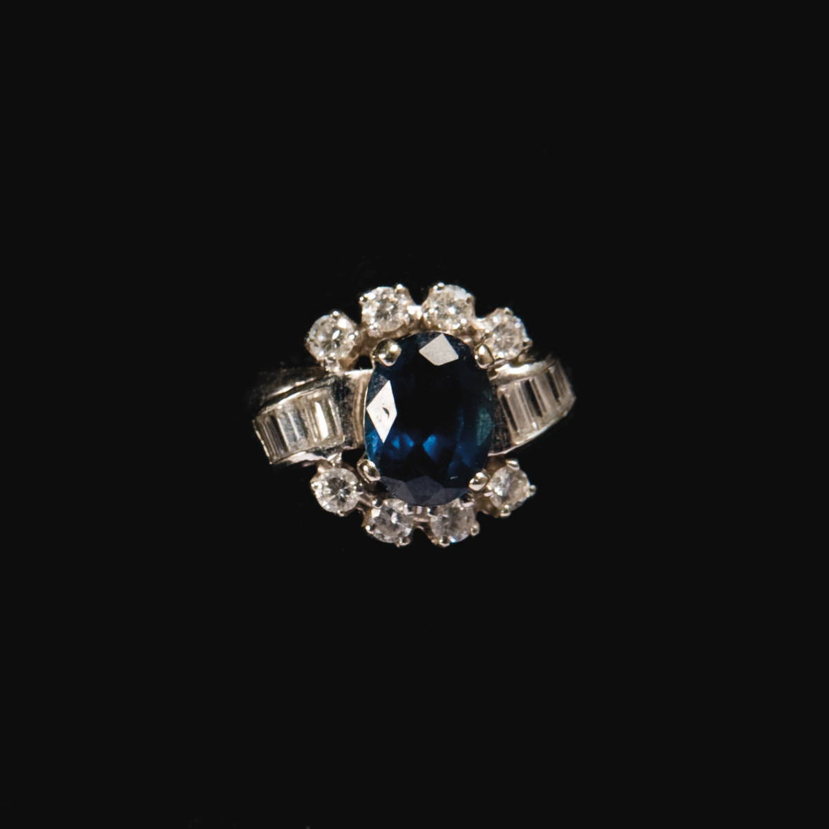 Appraisal: KT GOLD SAPPHIRE AND DIAMOND RING The oval sapphire surrounded