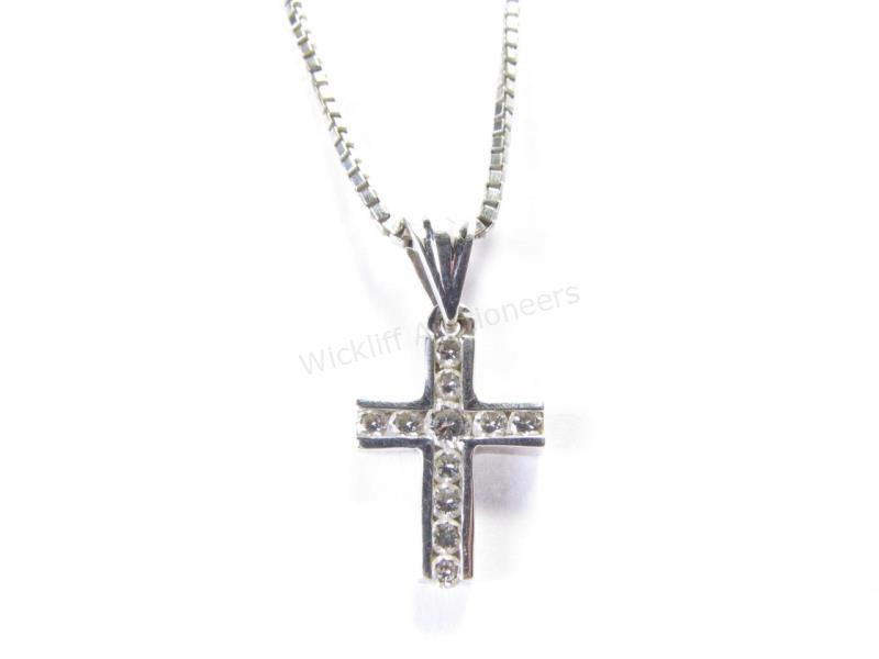 Appraisal: A K white gold cross pendant with eleven round brilliant