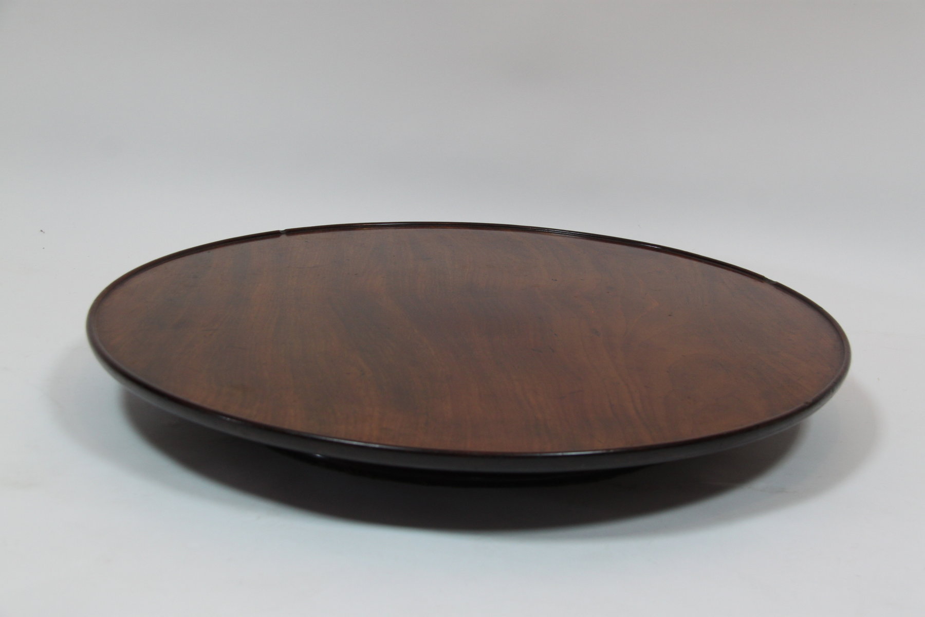 Appraisal: A George III mahogany lazy Susan the circular dished top