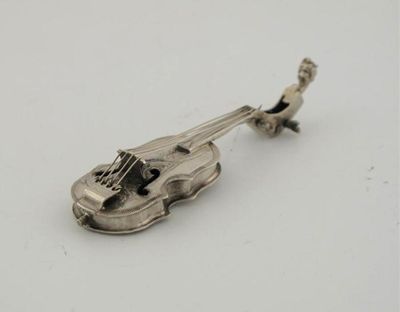 Appraisal: A violin with realistically formed strings embossed classical scene on