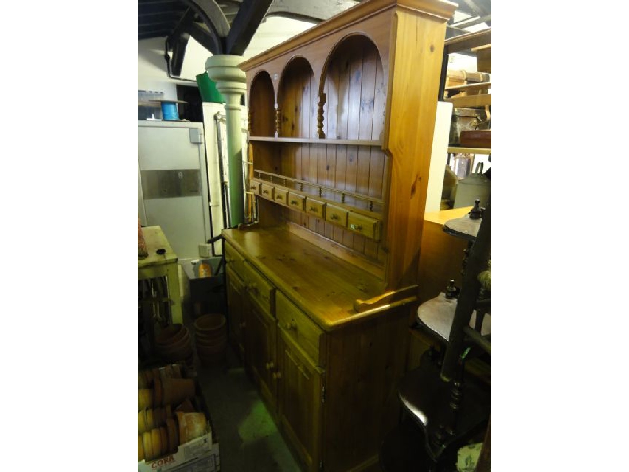 Appraisal: A contemporary stripped pine kitchen dresser the base enclosed by