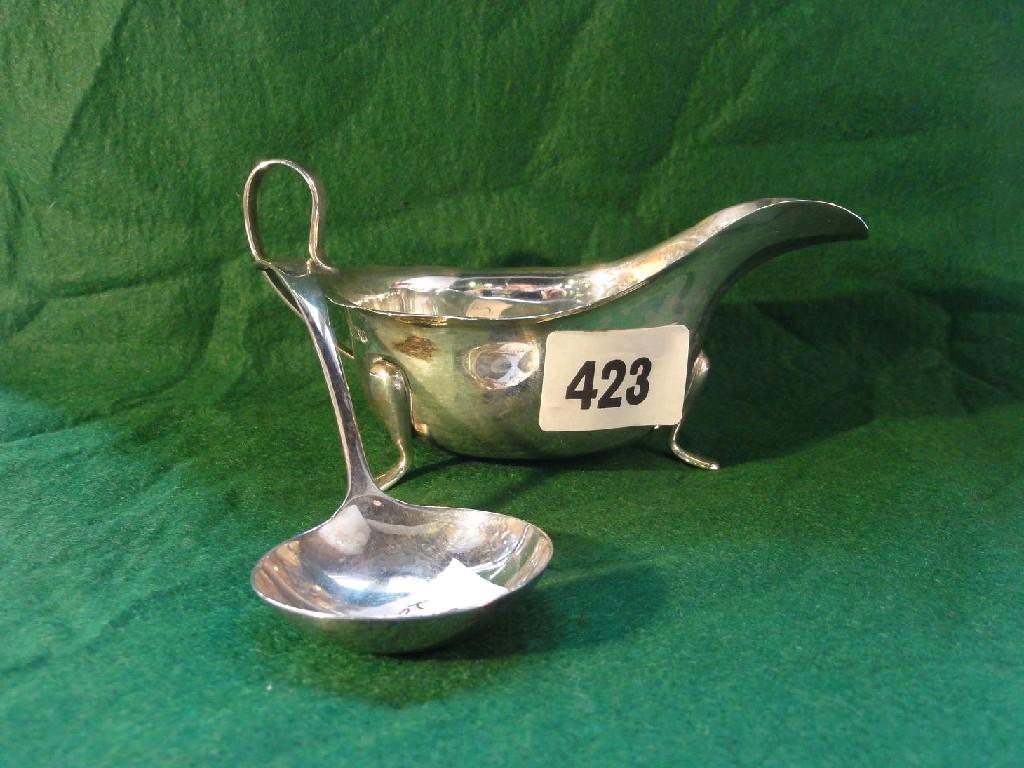 Appraisal: A Georgian style silver sauce boat with loop handle pedestal