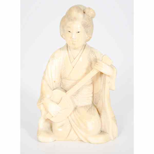 Appraisal: Japanese Ivory Figure Japanese A carved and inked ivory figure