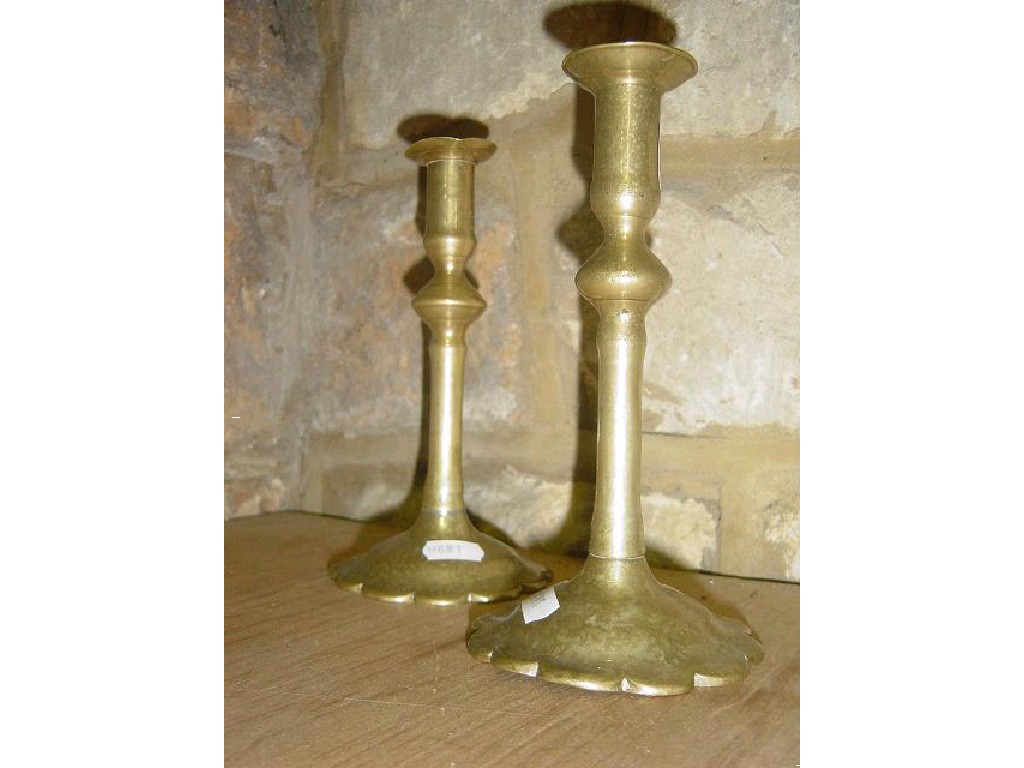 Appraisal: A pair of worn th century brass column candlesticks with