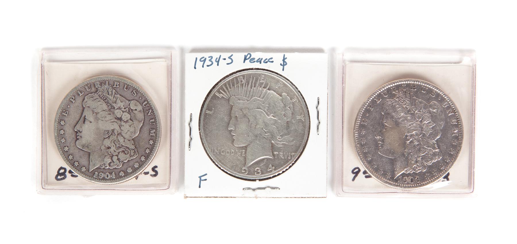 Appraisal: THREE SILVER DOLLARS Morgan -S Morgan and a -S Peace