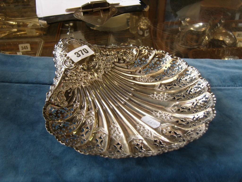 Appraisal: A silver scalloped shaped dish with embossed floral and swag