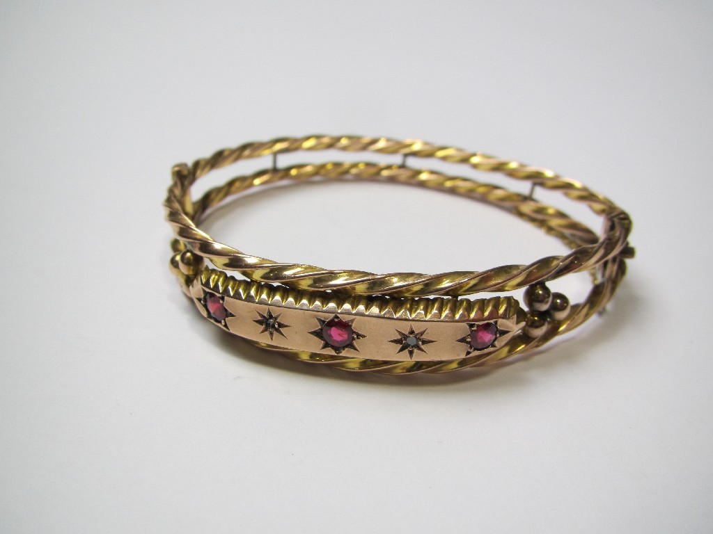 Appraisal: Victorian nine carat gold ruby and diamond set bangle