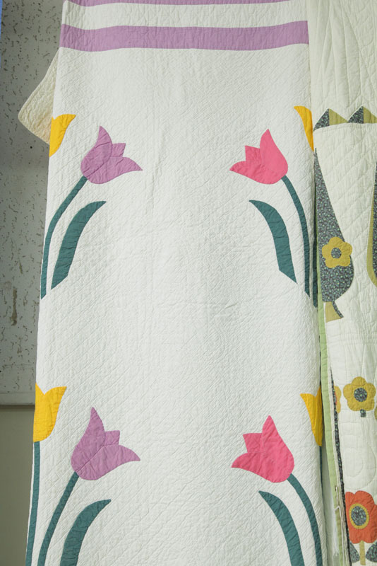 Appraisal: APPLIQUE QUILT With a tri-color tulip pattern in pink yellow