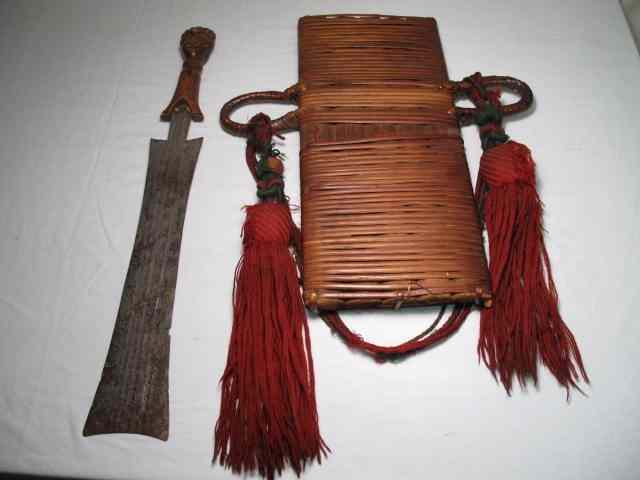 Appraisal: Tribal machete and sheath Carved wood figural handle on machete