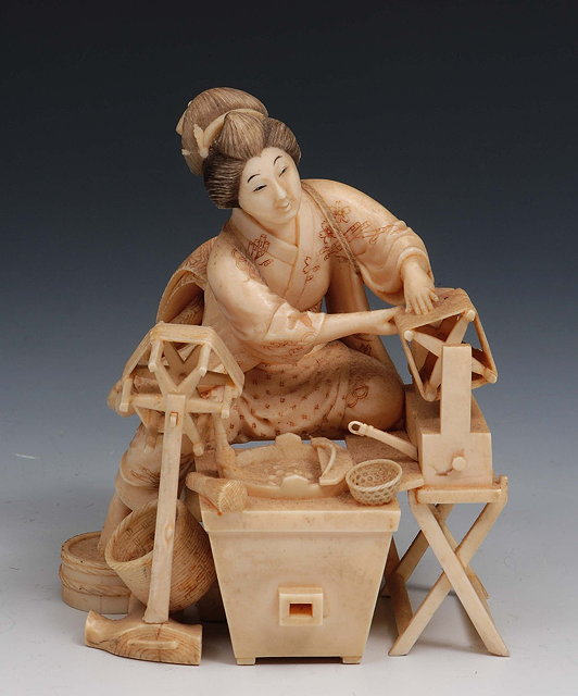 Appraisal: A Japanese ivory okimonoMeiji periodsigned carved as a woman at