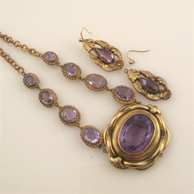 Appraisal: A short necklace mounted with amethyst in gold plated settings