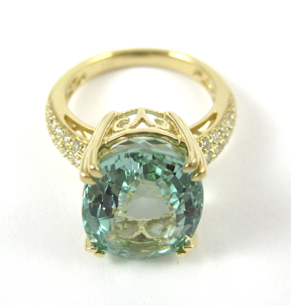 Appraisal: AQUAMARINE AND FOURTEEN KARAT GOLD RING with round-cut diamonds set