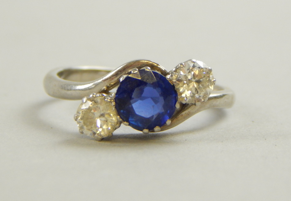 Appraisal: A sapphire and diamond three stone ring with central dark