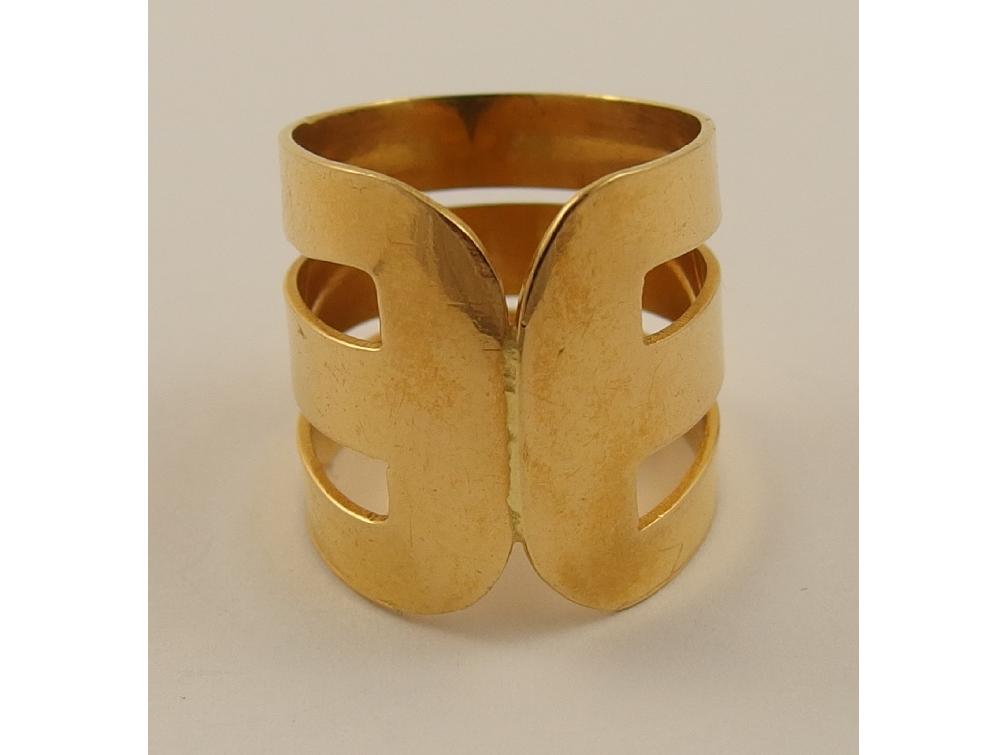 Appraisal: A ct wide band ring of abstract designstamped K to