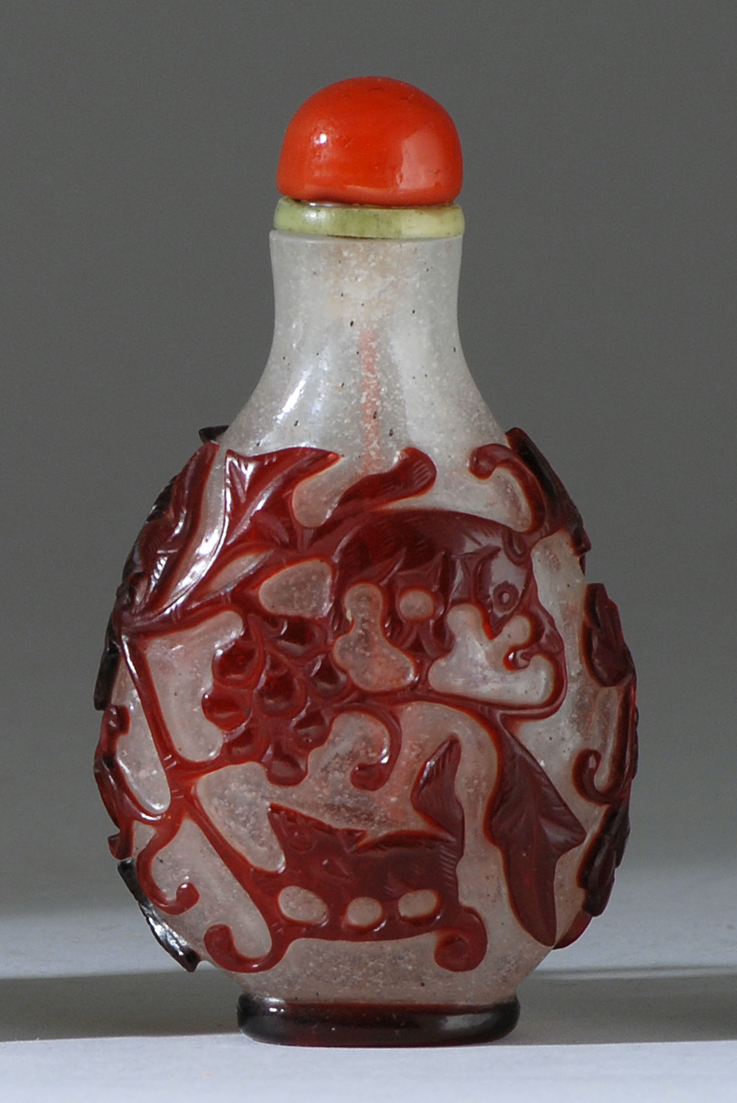 Appraisal: OVERLAY GLASS SNUFF BOTTLE th CenturyIn pear shape with squirrel