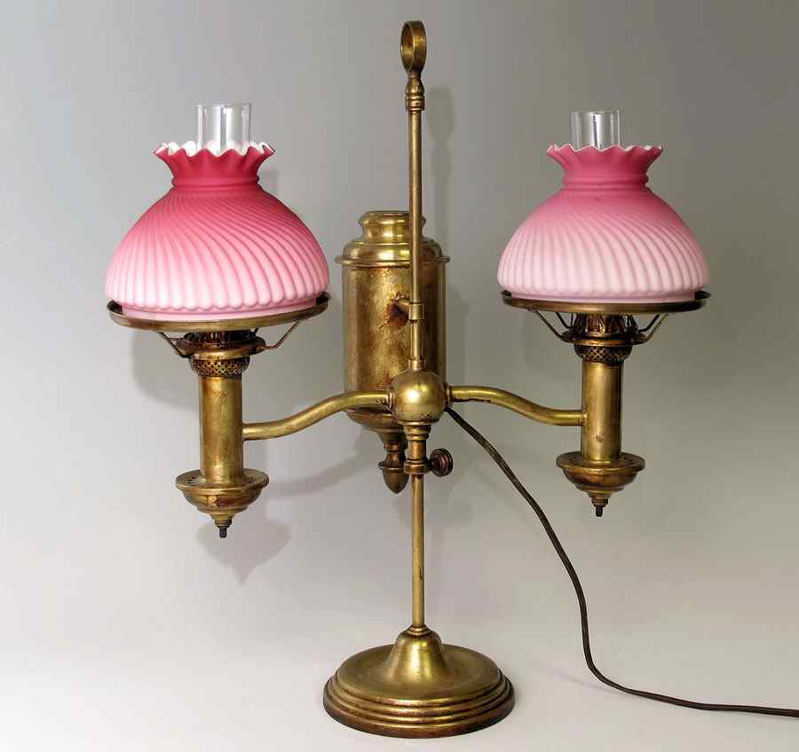 Appraisal: BRASS DOUBLE FONT STUDENT LAMP Swirl pink satin glass shades