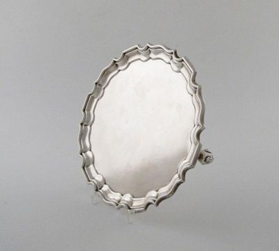 Appraisal: A silver waiter shaped circular form on three gnarl feet