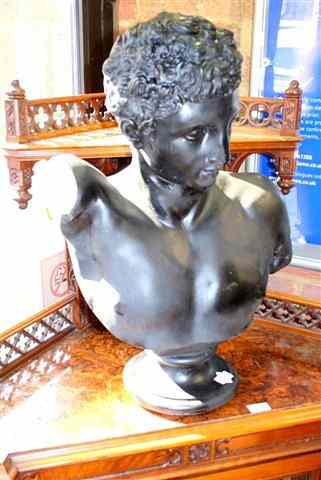 Appraisal: A BLACK PAINTED PLASTER BUST of a classical boy after