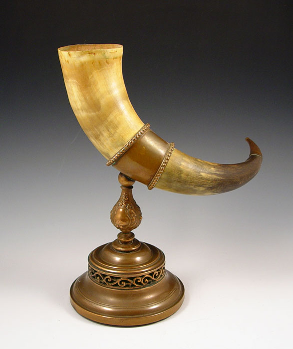 Appraisal: BRASS MOUNTED DRINKING HORN Brass ring stand base and tip